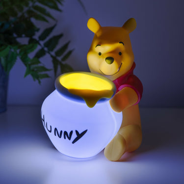 Winnie the Pooh light with Pooh holding a glowing honey pot with 'Hunny' on a dark background