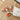 Wooden puzzle pieces with Tigger design on a wooden surface, next to a branded pouch.