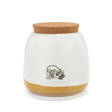 White jar with cork lid and bottom, featuring a bear illustration on a white background