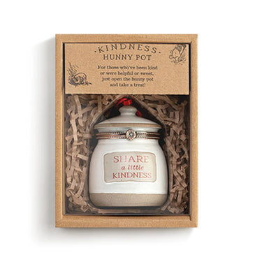 Small white jar with a lid labeled 'Share a Little Kindness' in a decorative box.