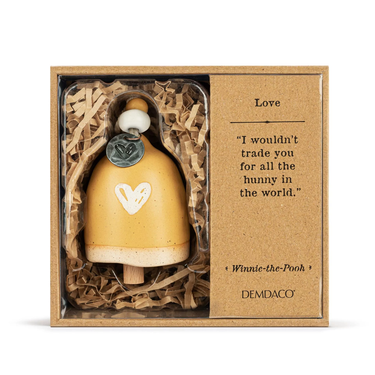 Demdaco Winnie the Pooh Mini Bell in packaging, predominantly yellow with a heart symbol, displayed on a white background.