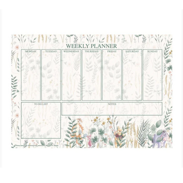 A Winnie the Pooh themed weekly planner desk pad with a floral pattern and spaces for writing daily activities, a to-do list, and notes.