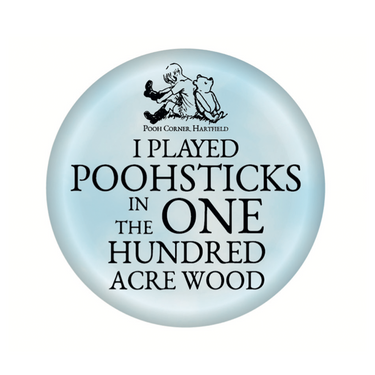 A round blue button badge with text and an illustration of Winnie-the-Pooh.