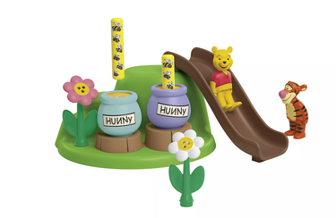 Toy set with Winnie the Pooh, Tigger, and honey pots on a white background