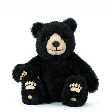 Black teddy bear with a white face on a white background