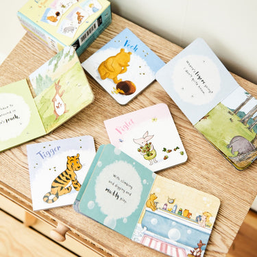 Collection of small children's books with animal illustrations on a wooden surface