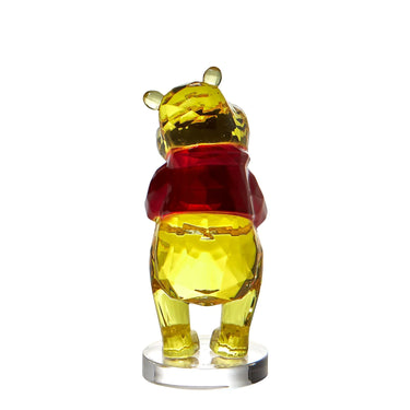 Glass figure of a bear with a red shirt on a clear stand against a white background