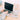 Person using a laptop on a desk with a mouse pad