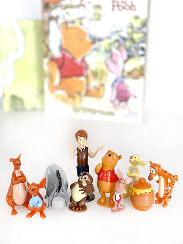 Set of Winnie the Pooh and friends figurines with a blurred background featuring a character from the same series.