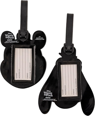 Two black luggage tags shaped like ears with a Winnie the Pooh design on a white background.