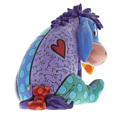 Colorful Eeyore figurine with heart and text on a white background