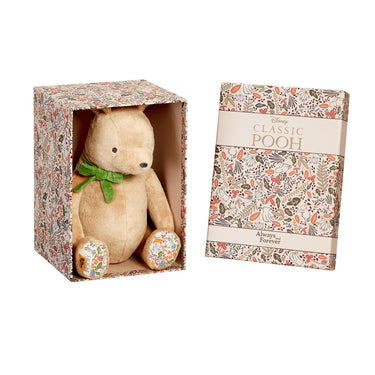 Stuffed bear toy with floral patterned box and 'Disney Classic Pooh' packaging.