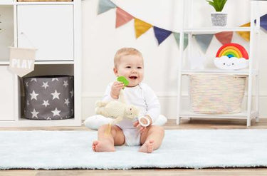 Baby playing with Classic Pooh on the go activity toy 