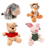 A collection of four plush toy figures, including a bear and animal characters in soft colors.