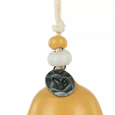 Decorative hanging bell with wooden and ceramic beads on a white background