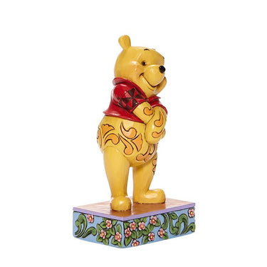 Side view of Disney Traditions Beloved Bear figurine by Jim Shore