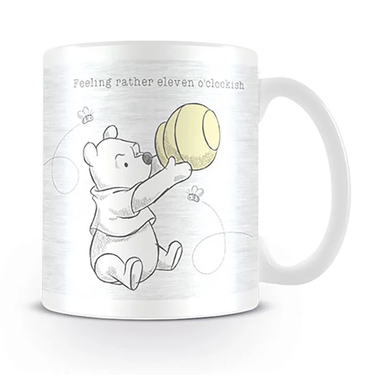 Mug with cartoon character holding a ball and text 'Feeling rather eleven o'clockish' on a white background