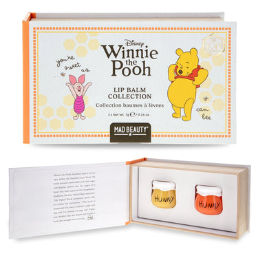 Mad Beauty Disney Winnie the Pooh Lip Balm Collection shown in its outer packaging and opened to reveal two small lip balm jars labeled 'HUNNY' inside a wooden tray.