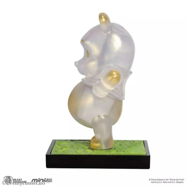 Translucent Pooh figurine on a green base with a white background