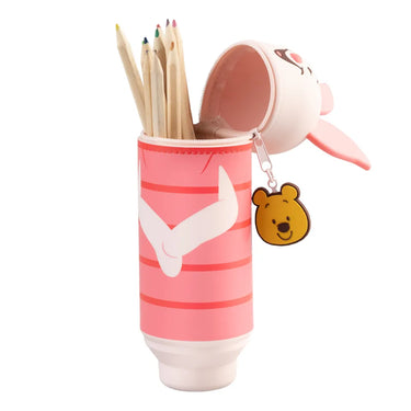 Pink pencil case with cartoon character and pencils on a white background
