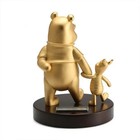 Gold and bronze statue of a bear and cub on a black base