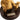Gold statue of a bear holding a smaller figure on a dark brown base with a label.