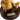 Gold statue of a bear holding a smaller figure on a dark brown base with a label.