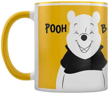 Mug with a cartoon bear design and 'POOH' text on a yellow background