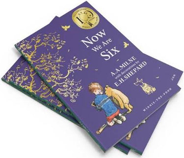 Book titled 'Now We Are Six' by A.A. Milne with a purple cover and gold accents.