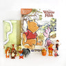A Winnie the Pooh themed Busy Book with colorful illustrations, a playmat, and several figurines of characters including Winnie the Pooh and Piglet.